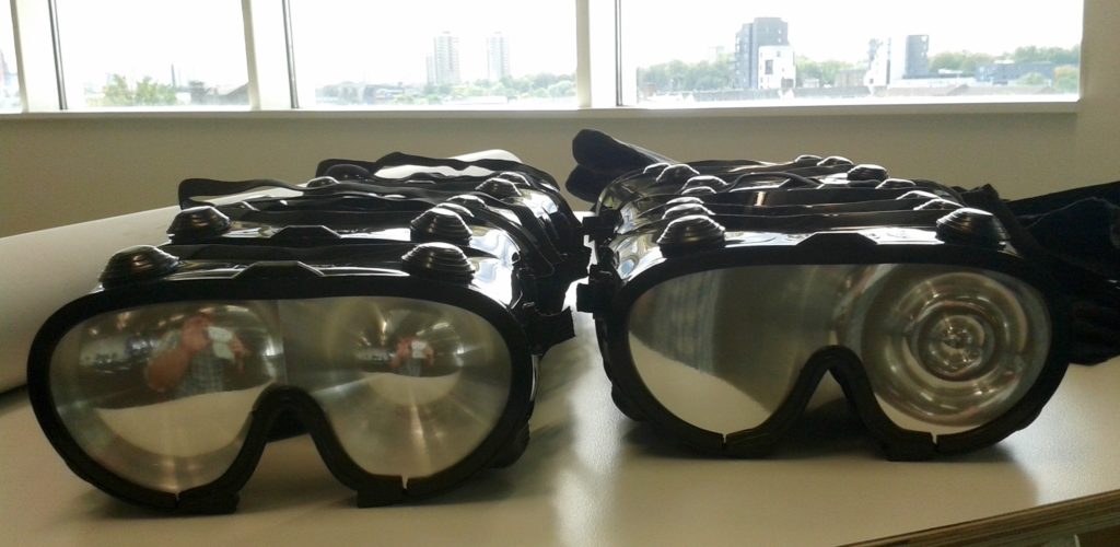 rows of goggles with mirrored lenses on a table