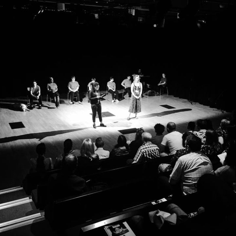 Black and white photo of participants on stage at mac Birmingham for the final sharing