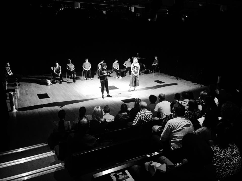 Black and white photo of participants on stage at mac Birmingham for the final sharing
