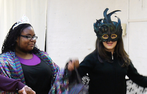 four young performers in sequinned costumes take a bow