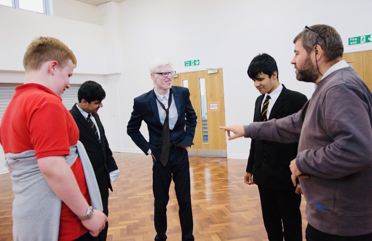 Four secondary school-age boys and an older man