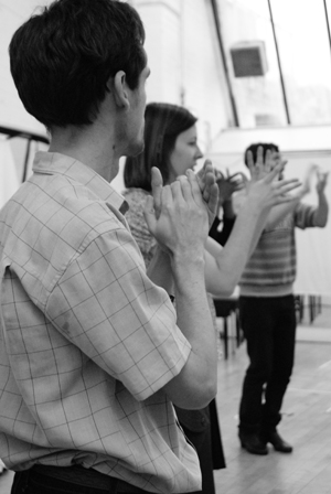 Two people  flamenco clap reflected in studio mirrors