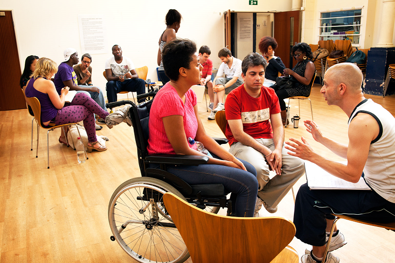 A group of participants sitting in a workshop like setting, deep in discussion.