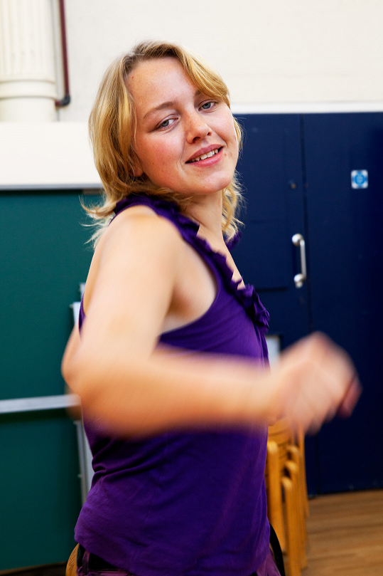 Lucy smiles as she throws a mock punch at the camera