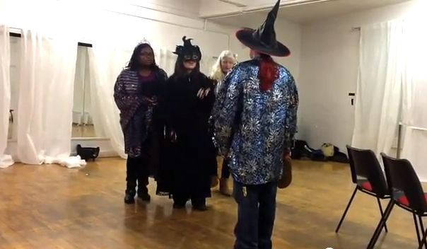 Young performers in witches hats and masks. Film of participation project