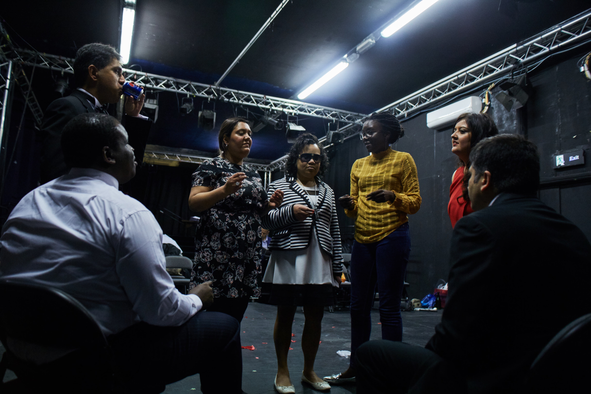 A pre-show warm up - the group of six stand in a circle, with the 3 women (centre) clicking their fingers.