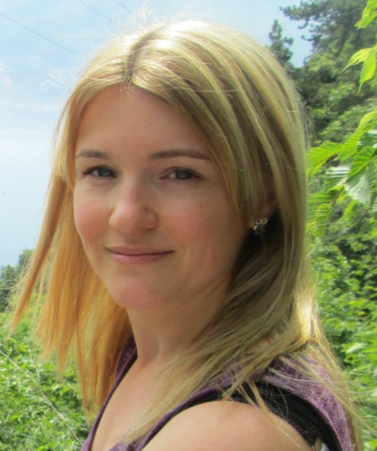 Headshot of Jodie Stus, a white female, smiling at camera