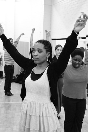 Woman dances samba with her arms in the air