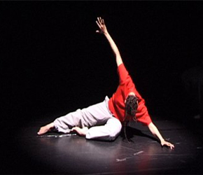 A dancer stretches on the floor
