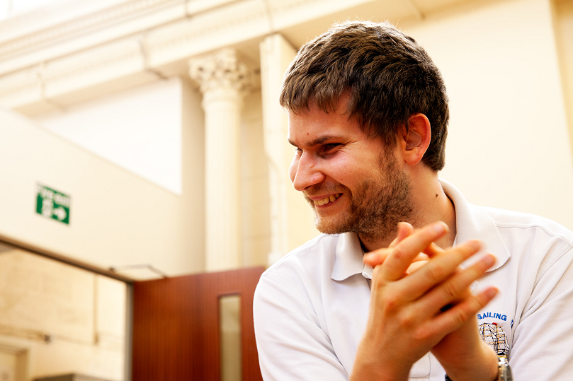 David, a young man, laughs and claps his hands