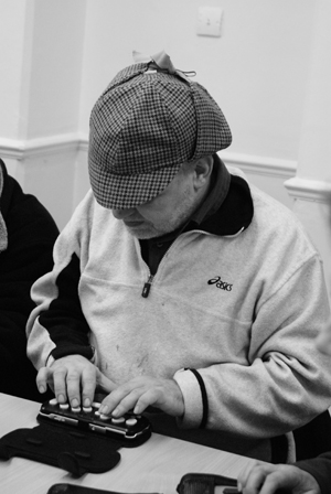 Man writes with a braille machine