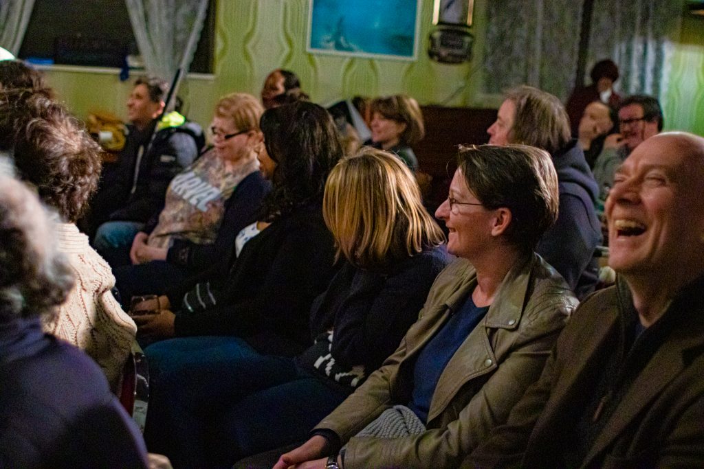 A closeup shot of audience members laughing