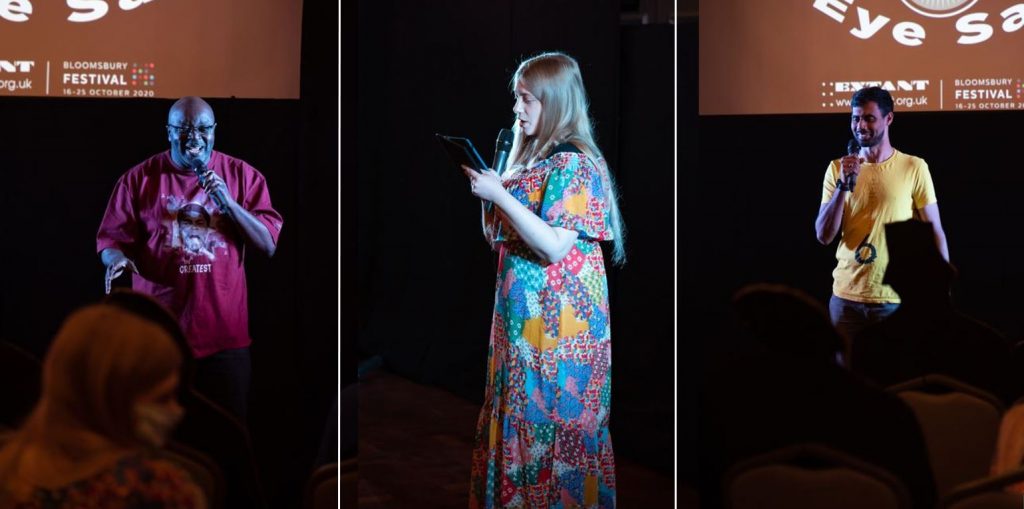 From left to right:
A vertical shot of Maverick, a man of African or Caribbean heritage talking into the microphone and grinning; A vertical close up of Amy, a young white woman, from a side perspective. She is spotlighted by stage lights and reading off her iPad with a microphone; A vertical shot of Naqi, a man of South Asian heritage smiling while talking into the microphone