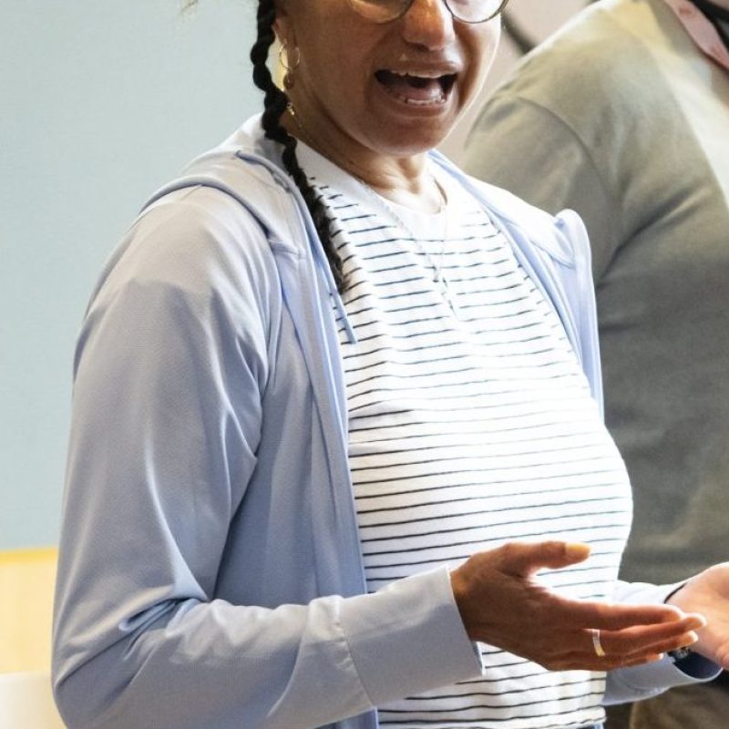 Maria is talking in a workshop space to participants.